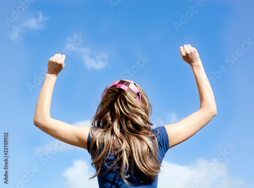 Portrait of a blond woman punching the air