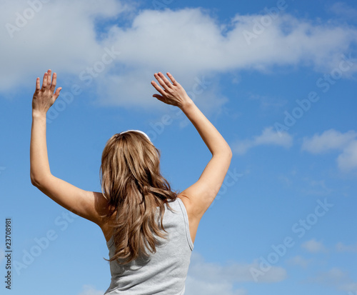 Caucasian woman doing yoga against a blue sky