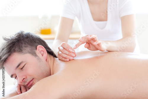 Smiling young man in an acupuncture therapy
