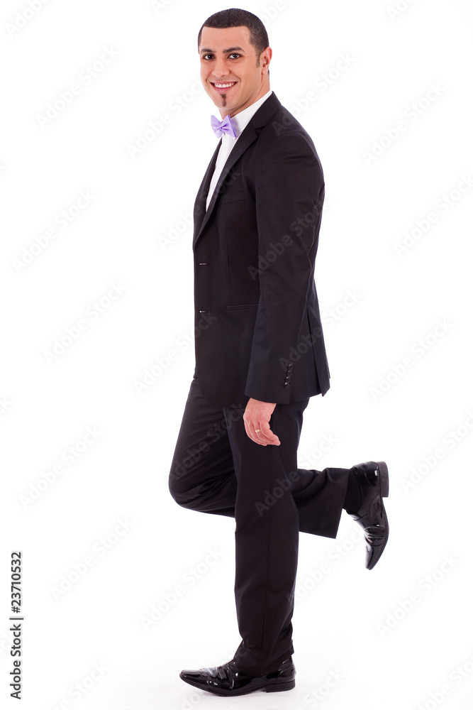 Full length of a business man leaning against the wall