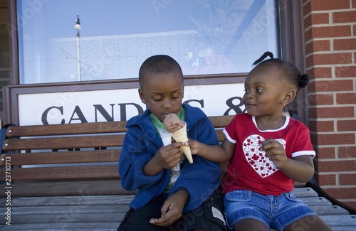 Boy And Girl Sharing Ice Cream Cone photo