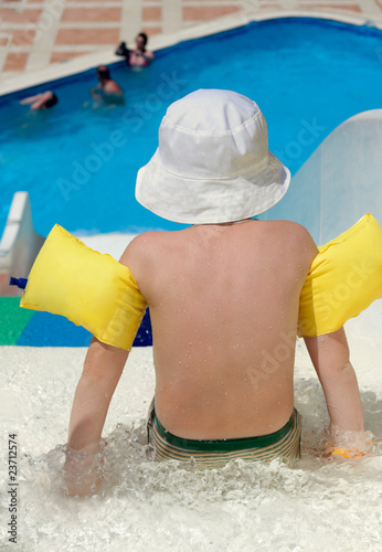 The little boy is going to slide