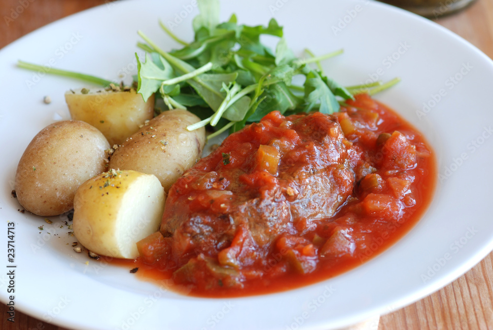 Sirloin steak with pizzaiola sauce and potatoes