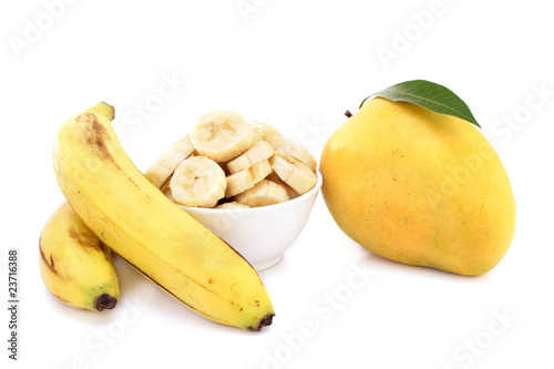 Mango and bananas on white