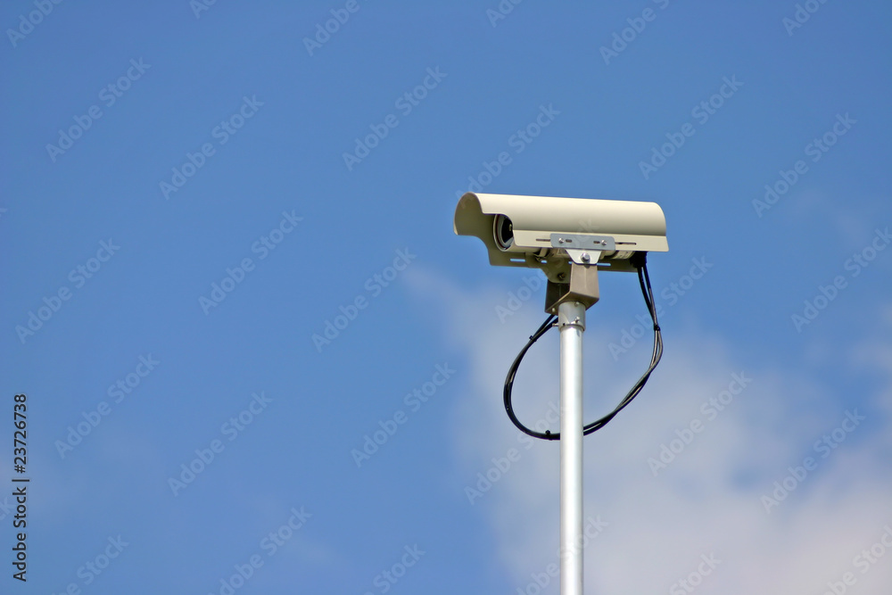 Security camera in cloudy blue sky background. Security camera in cloudy blue sky background.