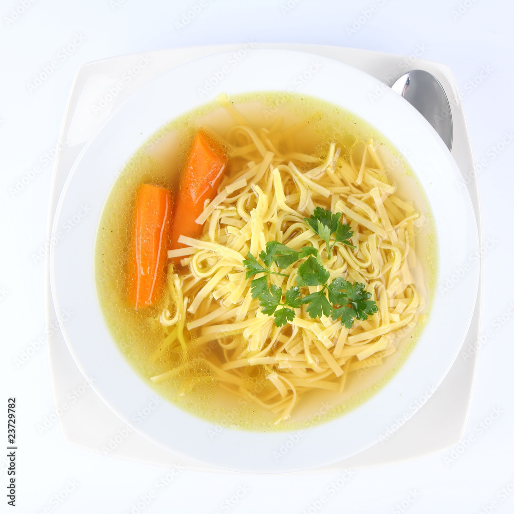 Chicken soup with macaroni and carrots and a spoon Chicken soup with macaroni and carrots and a spoon