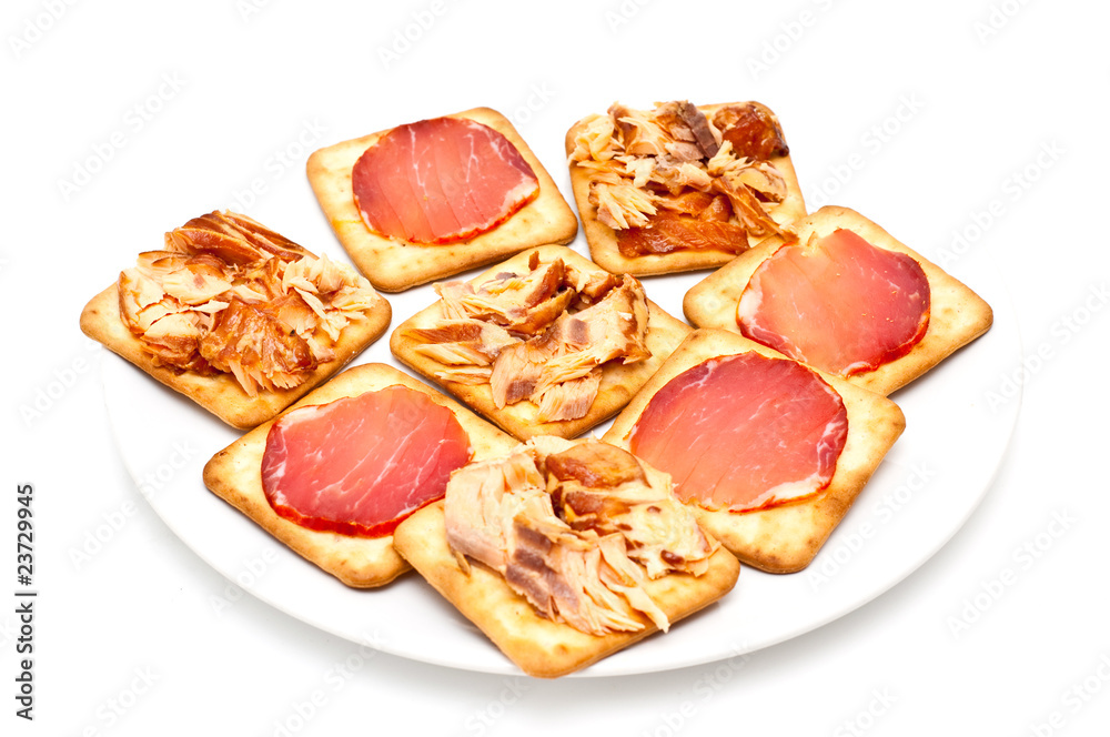 crackers topped with smoked salmon and meat