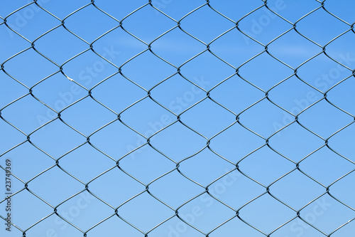 Detailed wire fence against blue sky