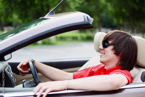 Young businessman sitting in a car.