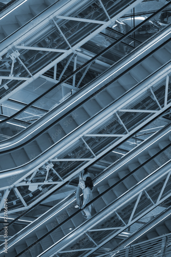 woman moving down an escalator