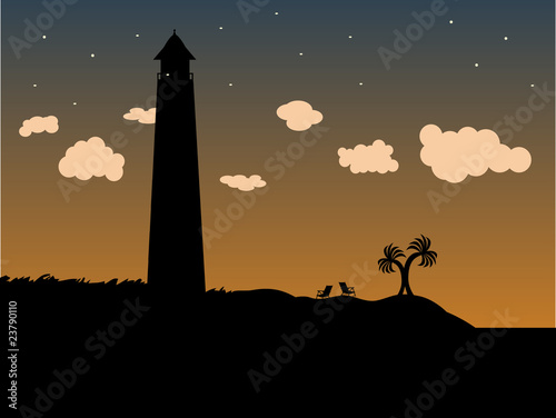 Lighthouse in the grass on the coast at dusk