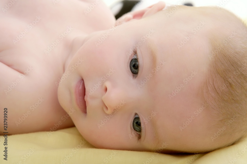 Blond little baby laying on bed portrait Blond little baby laying on bed portrait