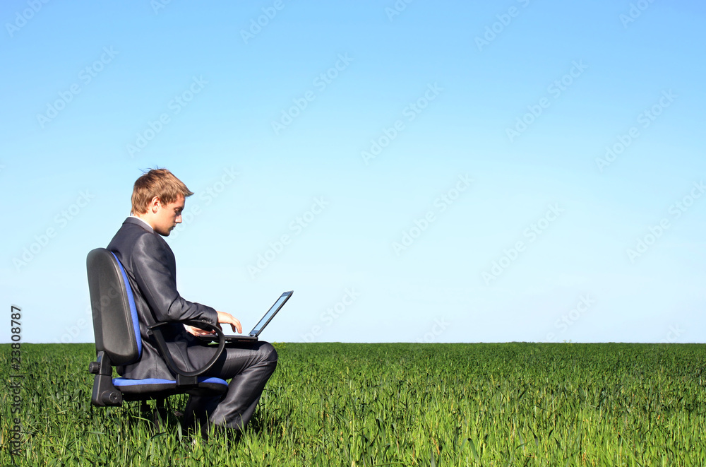 Successful businessman, in the field with laptop Successful businessman, in the field with laptop