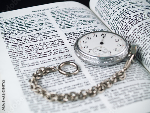 The Bible opened to Matthew 24: 36 with a Pocketwatch