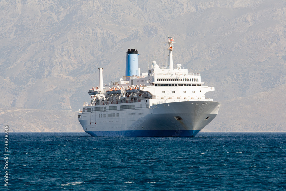 Tourist cruise sea liner is sailing in rocky bay