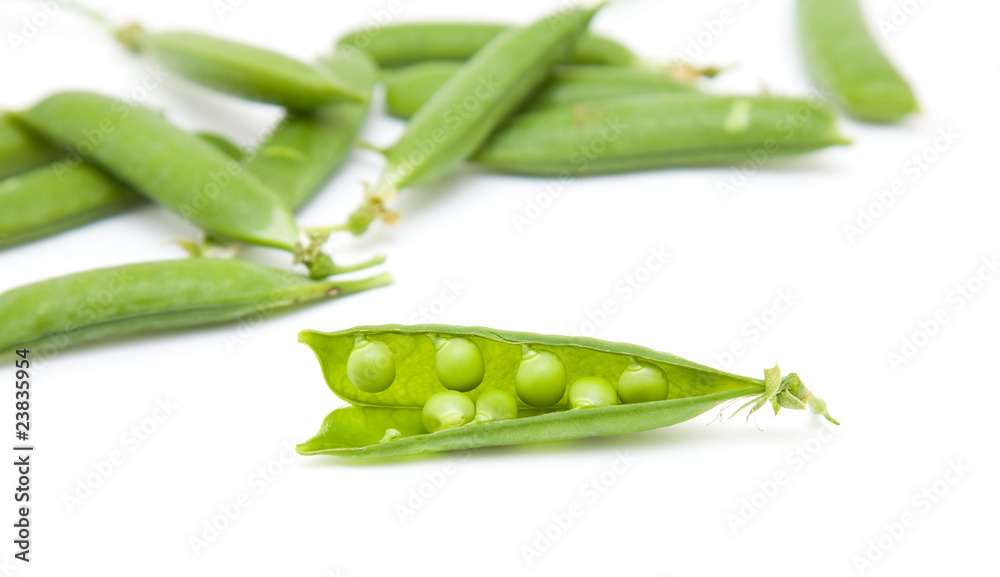 fresh green peapods on white surface; isolated fresh green peapods on white surface; isolated
