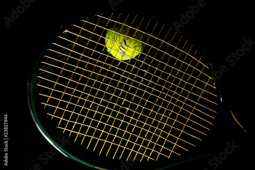 tennis racket and ball on black background © zimmytws