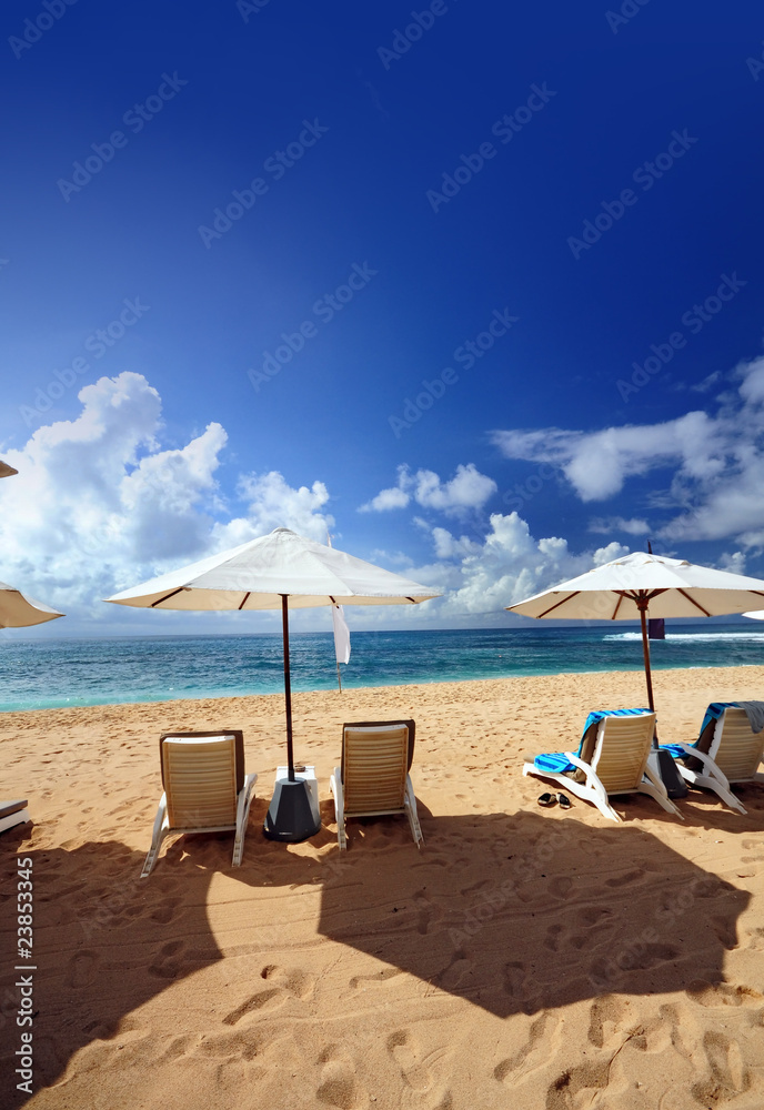 Beach scenery with chairs and umbrella