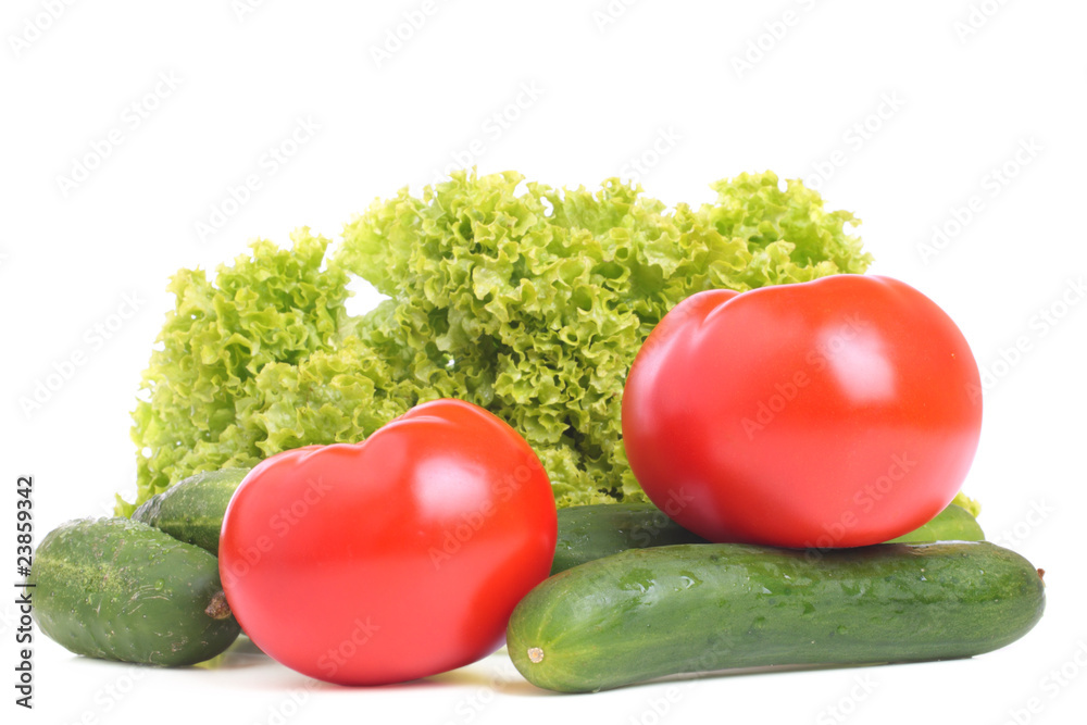 Fresh tomatoes, cucumbers and leaf lettuce on white Fresh tomatoes, cucumbers and leaf lettuce on white