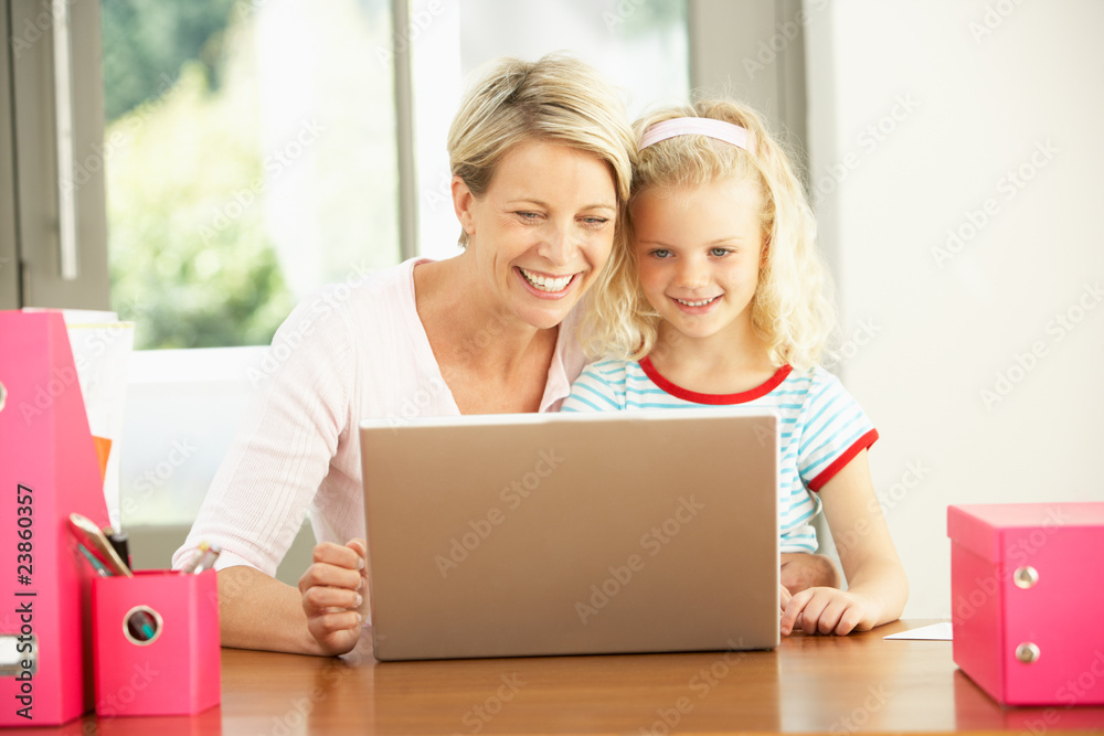 Mother And Daughter Using Laptop At Home
