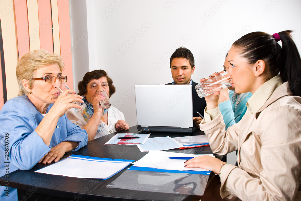 All business people drinking water at meeting All business people drinking water at meeting