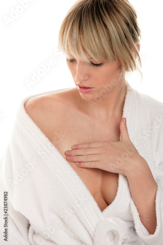 Woman applying cream on chest