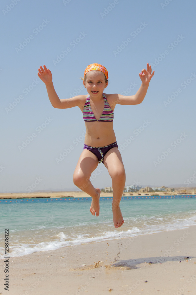 little girl jumping over the water little girl jumping over the water