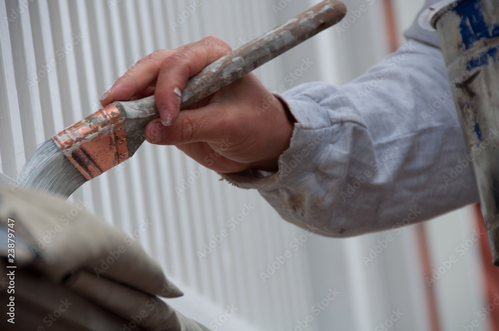 House Painter's Careful Hand Applies Exterior Paint House Painter's Careful Hand Applies Exterior Paint