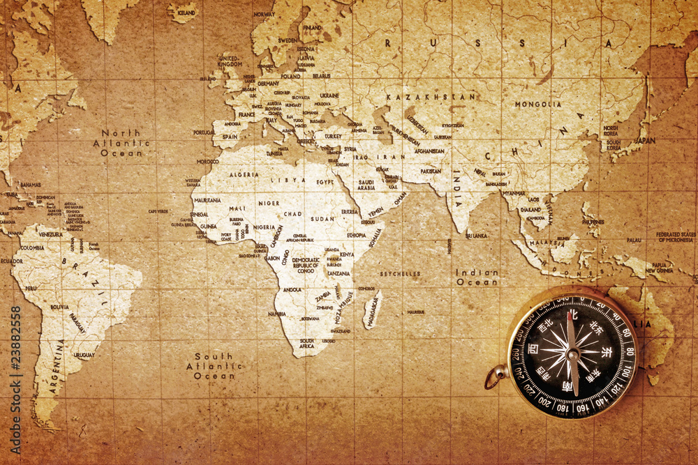 An old brass compass on a Treasure map background An old brass compass on a Treasure map background