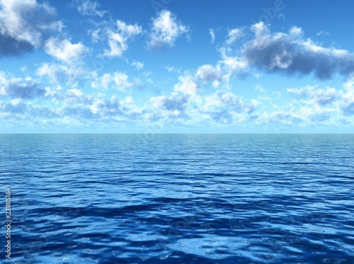 cloudy blue sky above a blue surface of the sea