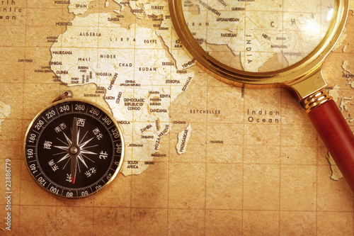 compass on a Treasure map background  with Magnifier