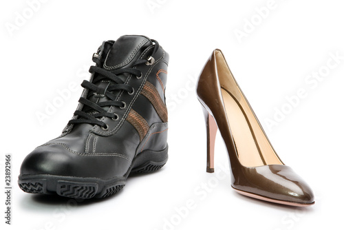 Men's boots and elegant female shoes on white background..
