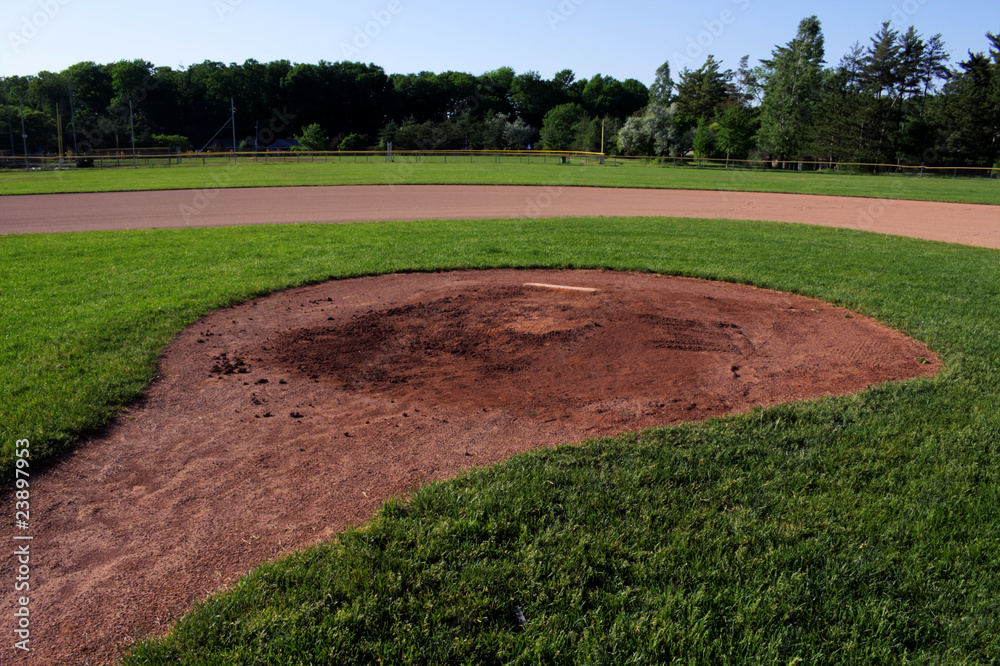 A wide angle shot of the pitchers mound at a baseball field.  The shot was created via HDR. (multiple exposures combined).