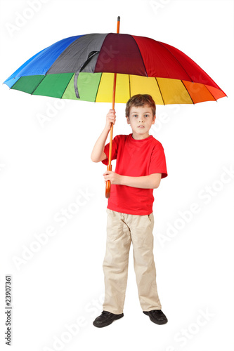 little boy in red shirt with big multicolored umbrella standing