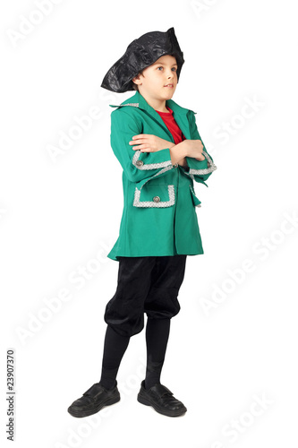 little boy in historical dress crossed hands standing on white