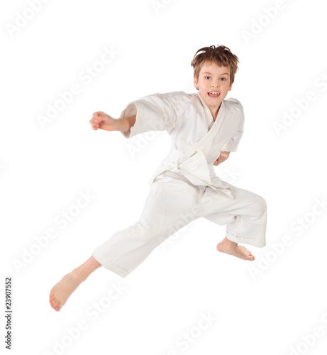 karateka boy in white kimono jumping isolated on white