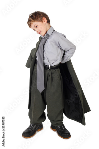 little boy in big grey man's suit and boots dressing jacket