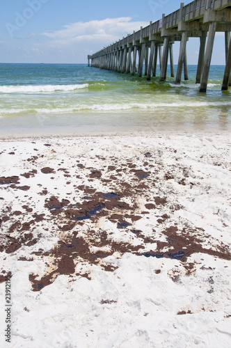 Large pools of oil wash ashore near the Pensacola Beach