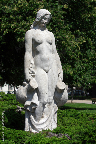 White statue of woman in the city park