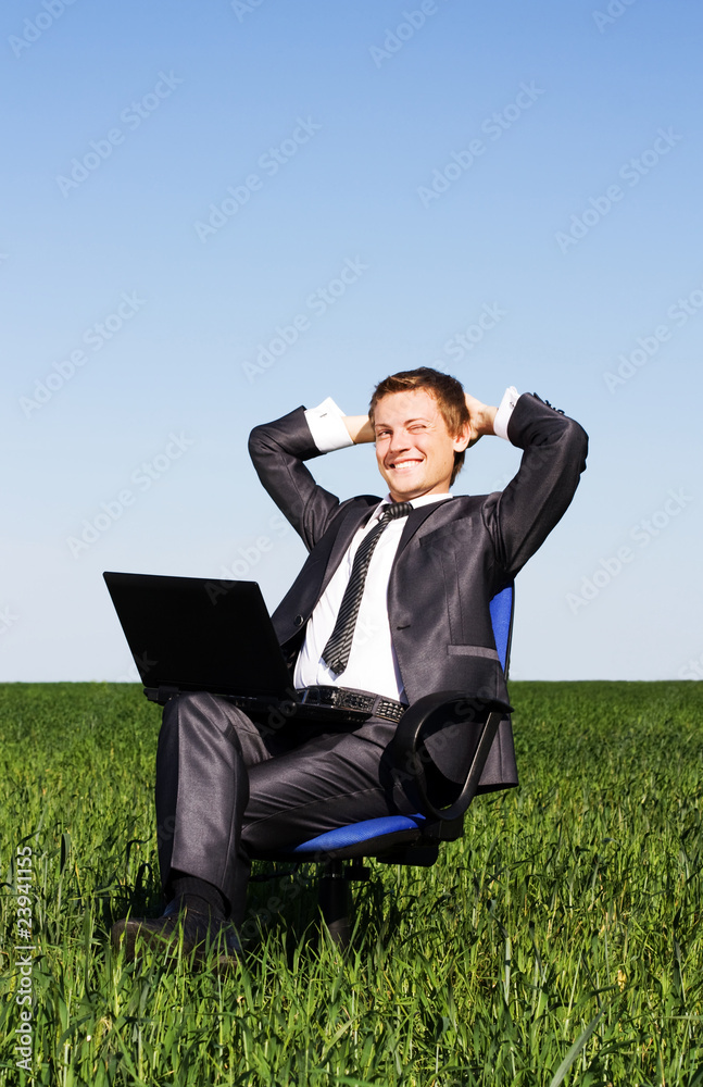 Businessman in the field, with a laptop. Happy, successful Businessman in the field, with a laptop. Happy, successful