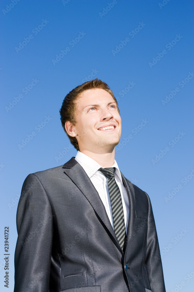 Successful businessman in a suit against the blue sky Successful businessman in a suit against the blue sky