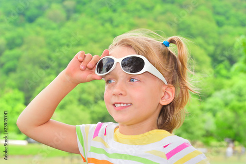 Little girl outside in sun glasses