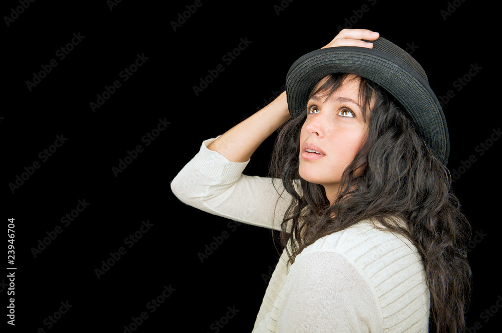 Beautiful woman wearing a hat on black background. Beautiful woman wearing a hat on black background.