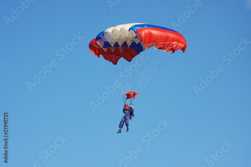 Canvastavla a parachute is in dark blue sky