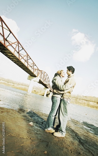 Couple Embrace In River Valley