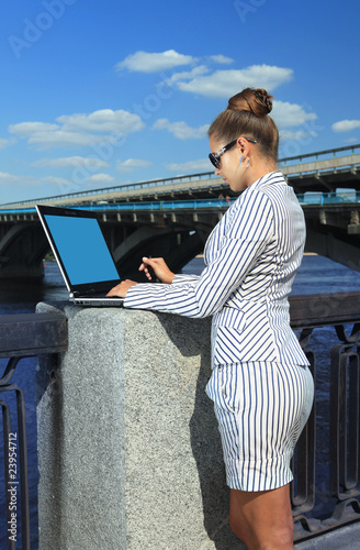 woman with laptop on quay