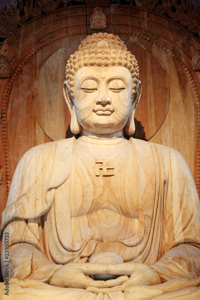 A golden Buddha sitting in the Asian Museum