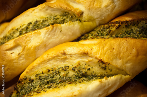 Freshly baked baguettes with herbs and butter.