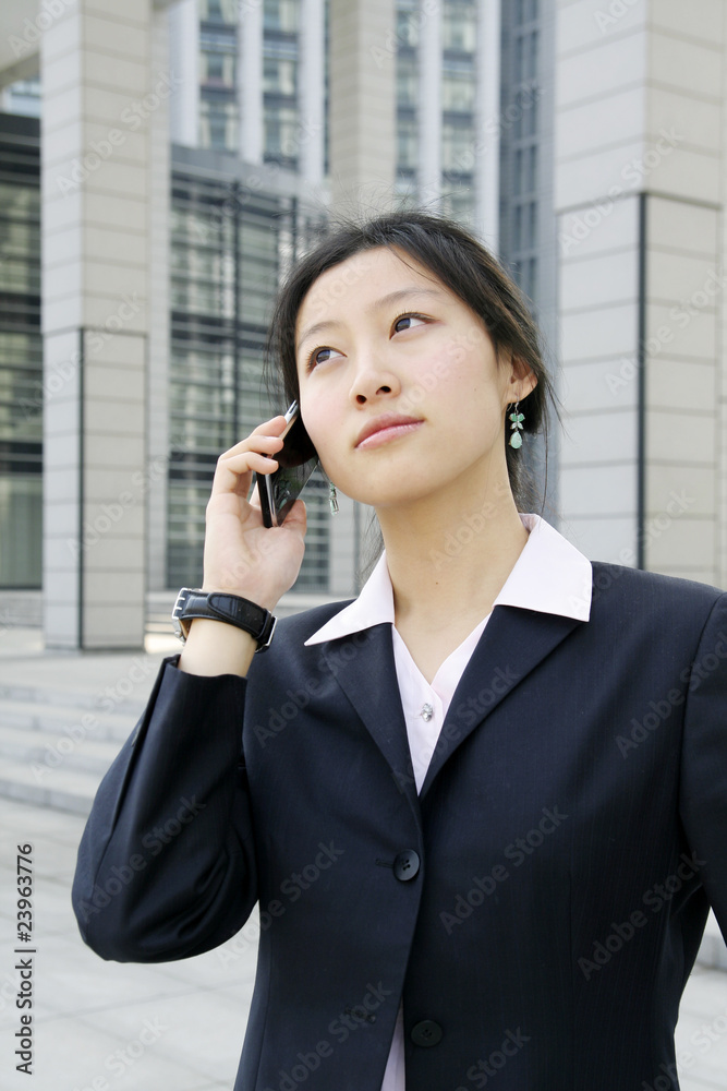 A beautiful Asian business woman on the phone A beautiful Asian business woman on the phone