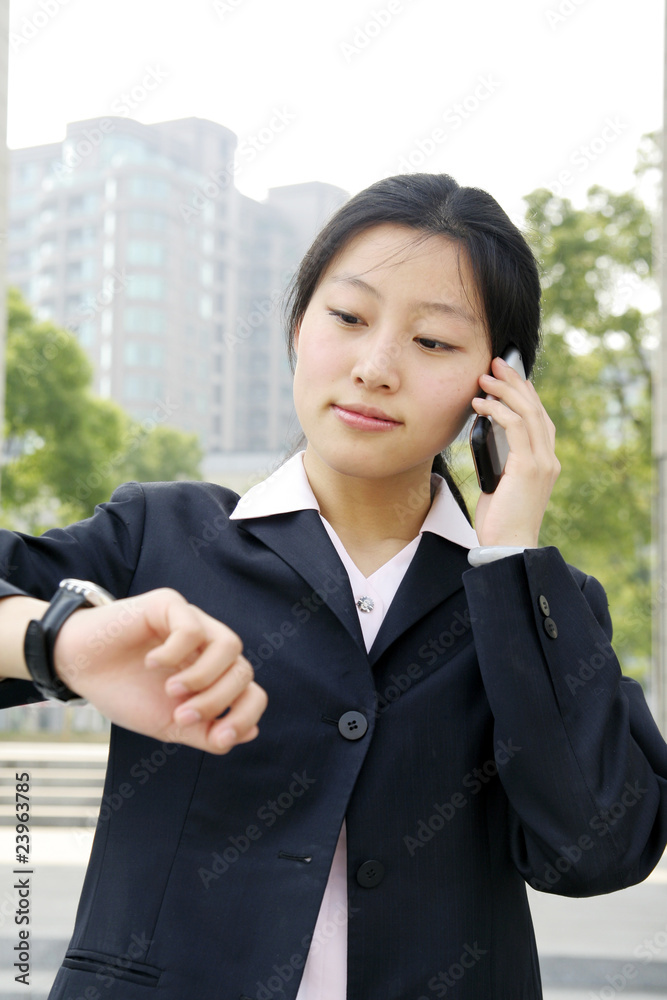 A beautiful Asian business woman on the phone A beautiful Asian business woman on the phone